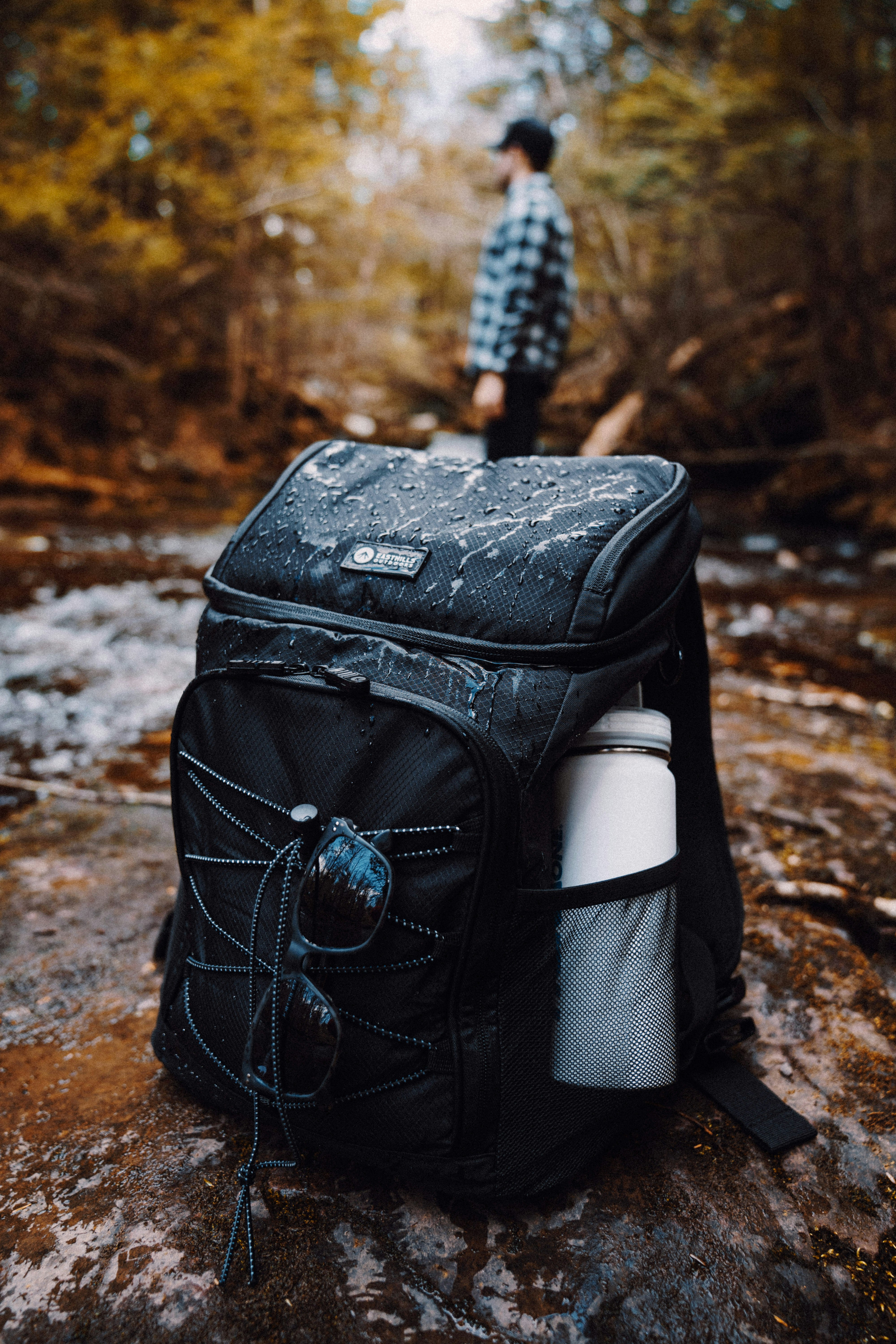 black backpack on brown and white rock